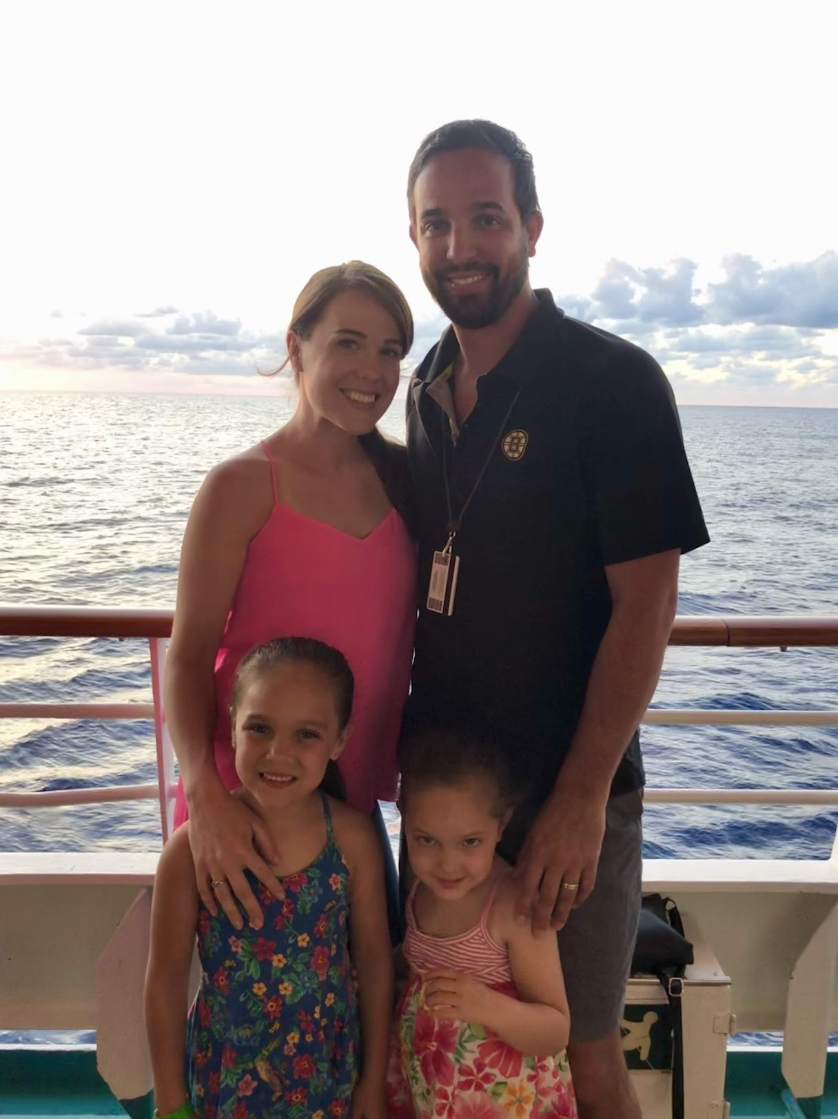 Mary, Michael and their daughters on a cruise ship at sunset
